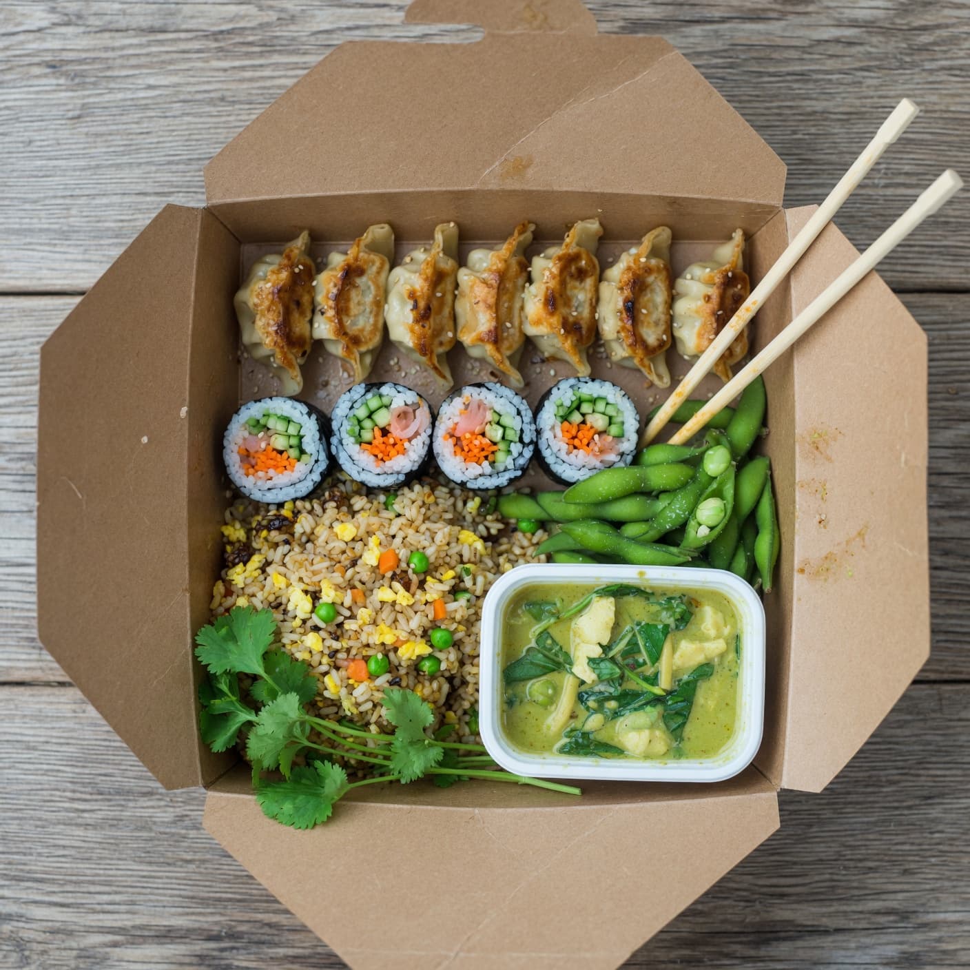 An overhead flatlay of a ResQBox surprise bag showing a variety of rescued meals